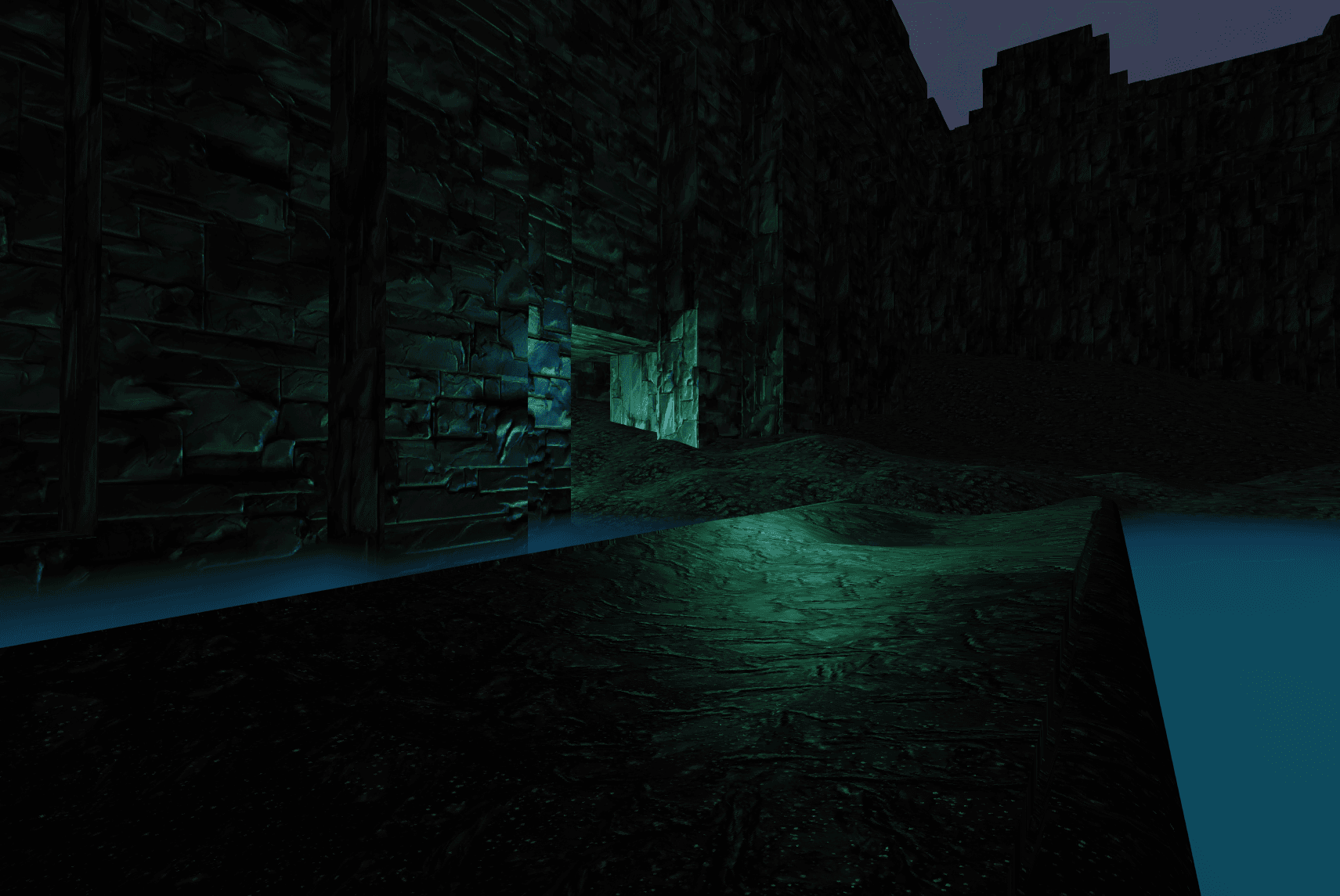 A screenshot of the cave level rendered with Three.JS.  It shows a large gray stone wall with a door in the bottom, illuminated by an eerie green light.  The player is standing on a shiny stone walkway/bridge which crosses over a depression in the terrain which is filled with blue volumetric fog.